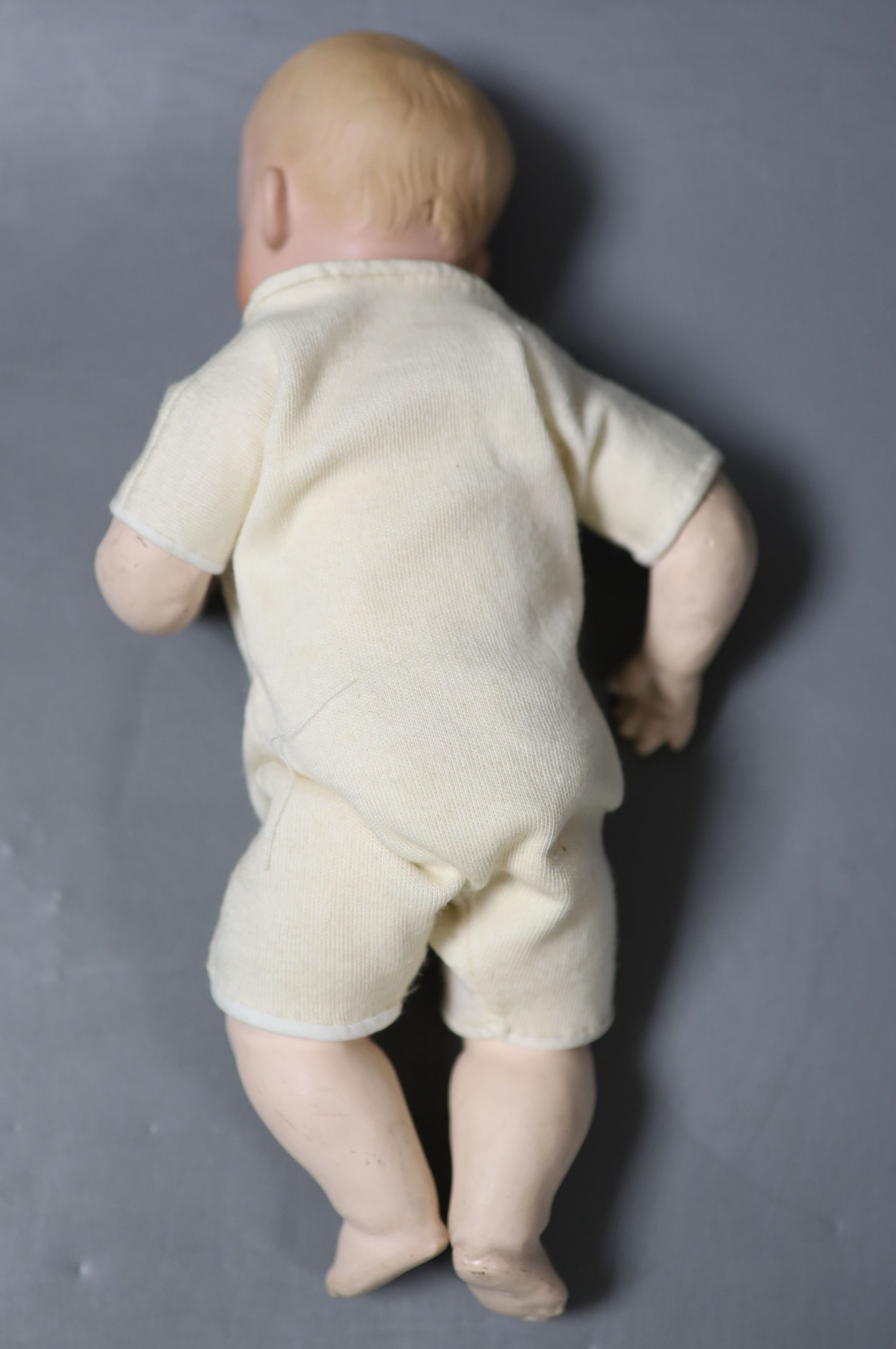 A Rose O'Neil Kewpie doll, arms detached, 26cm